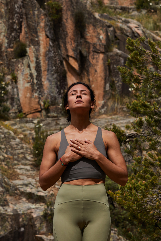 Fit Woman Meditating Outdoors