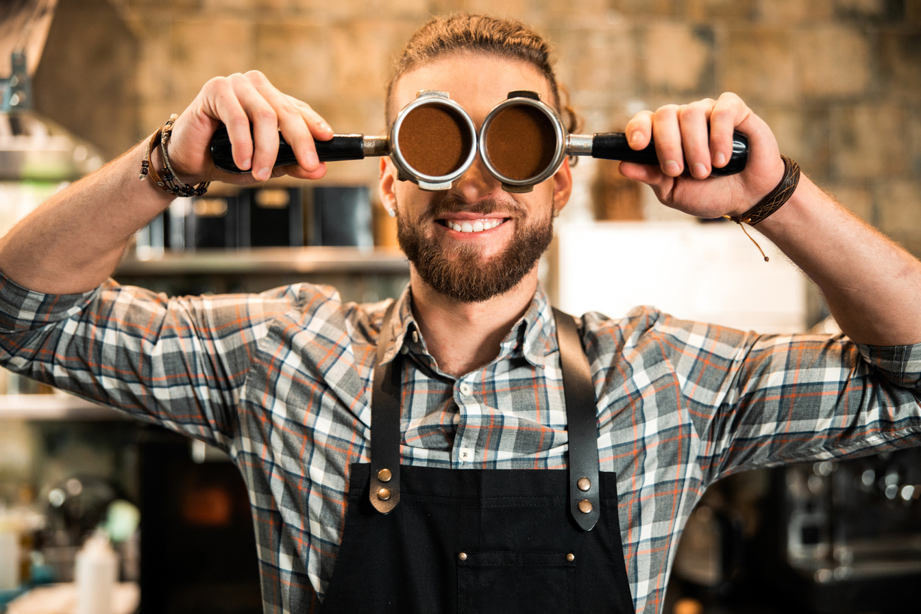 Happy young male entrepreneur in coffee shop